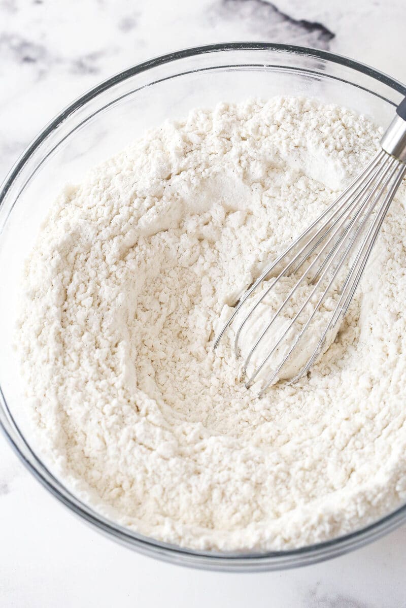 These brown sugar cutout cookies are the best! Browning the butter gives them a nutty, caramelized flavor and a dreamy, soft, chewy texture. Whisking together the dry ingredients for brown sugar cut out cookies dough.