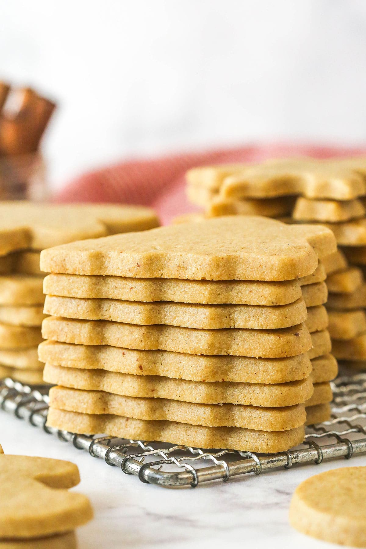 These brown sugar cutout cookies are the best! Browning the butter gives them a nutty, caramelized flavor and a dreamy, soft, chewy texture. A stack of brown sugar cutout cookies on a cooling rack.