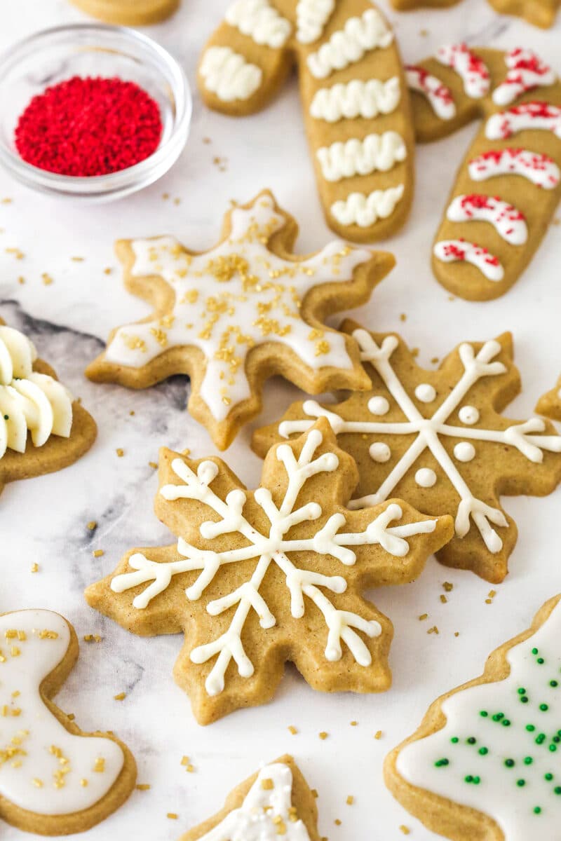 These brown sugar cutout cookies are the best! Browning the butter gives them a nutty, caramelized flavor and a dreamy, soft, chewy texture. Brown sugar cutout cookies decorated for Christmas.
