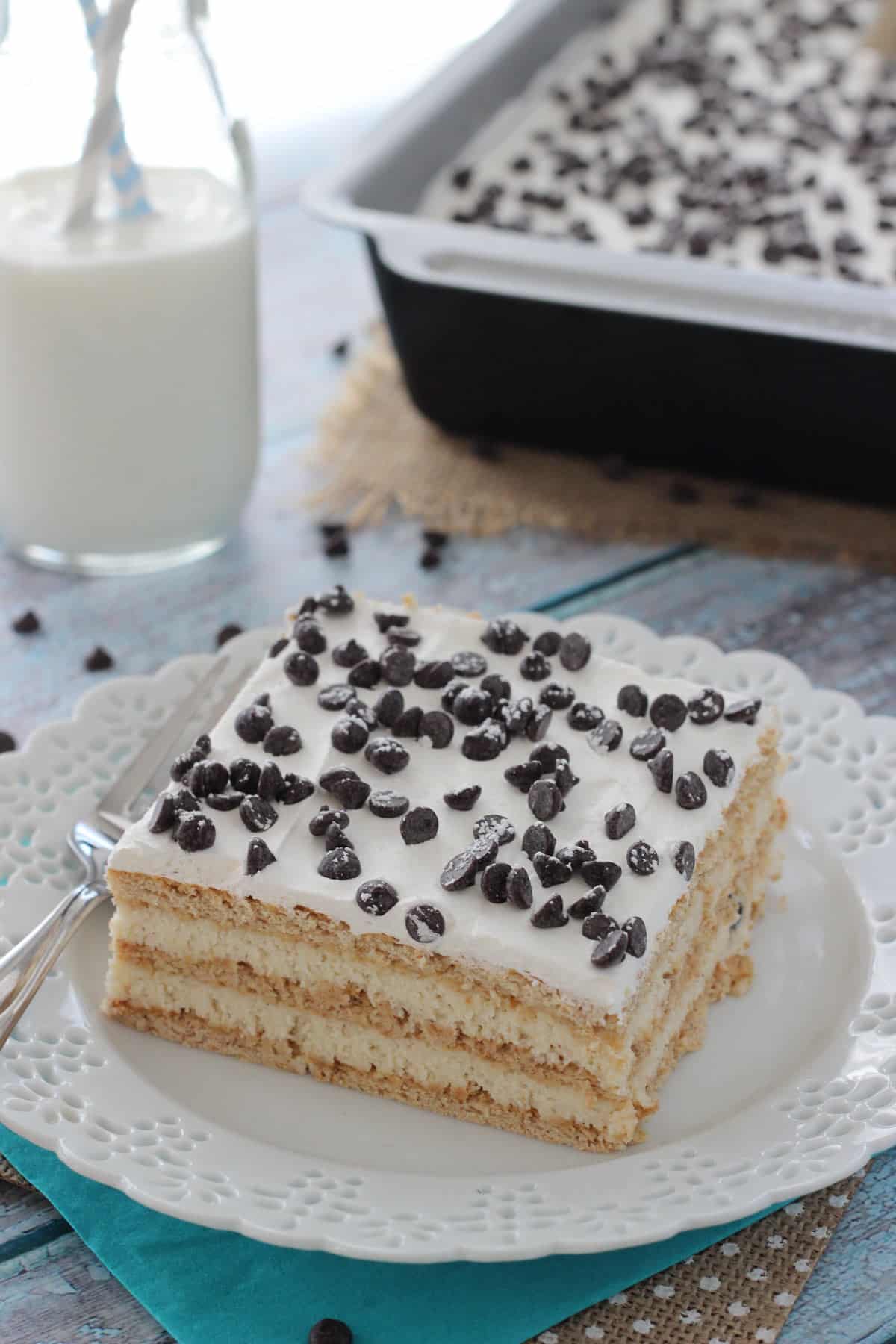 Top view of a slice of cannoli icebox cake on a white plate.