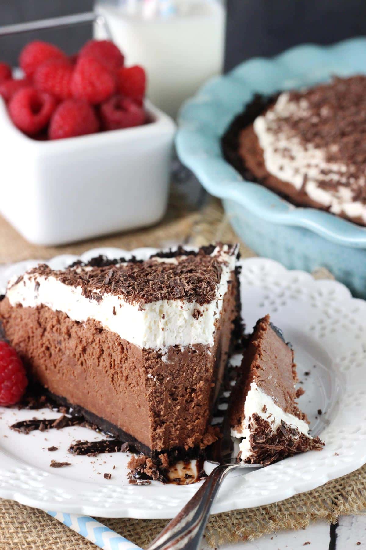 A slice of chocolate truffle pie with a bite removed on a fork.