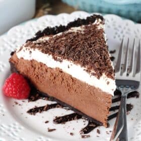 A slice of chocolate truffle pie on a white plate.
