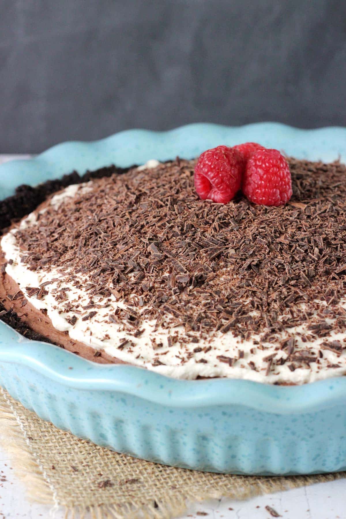 Close up of a chocolate truffle pie in a blue ceramic pie pan.