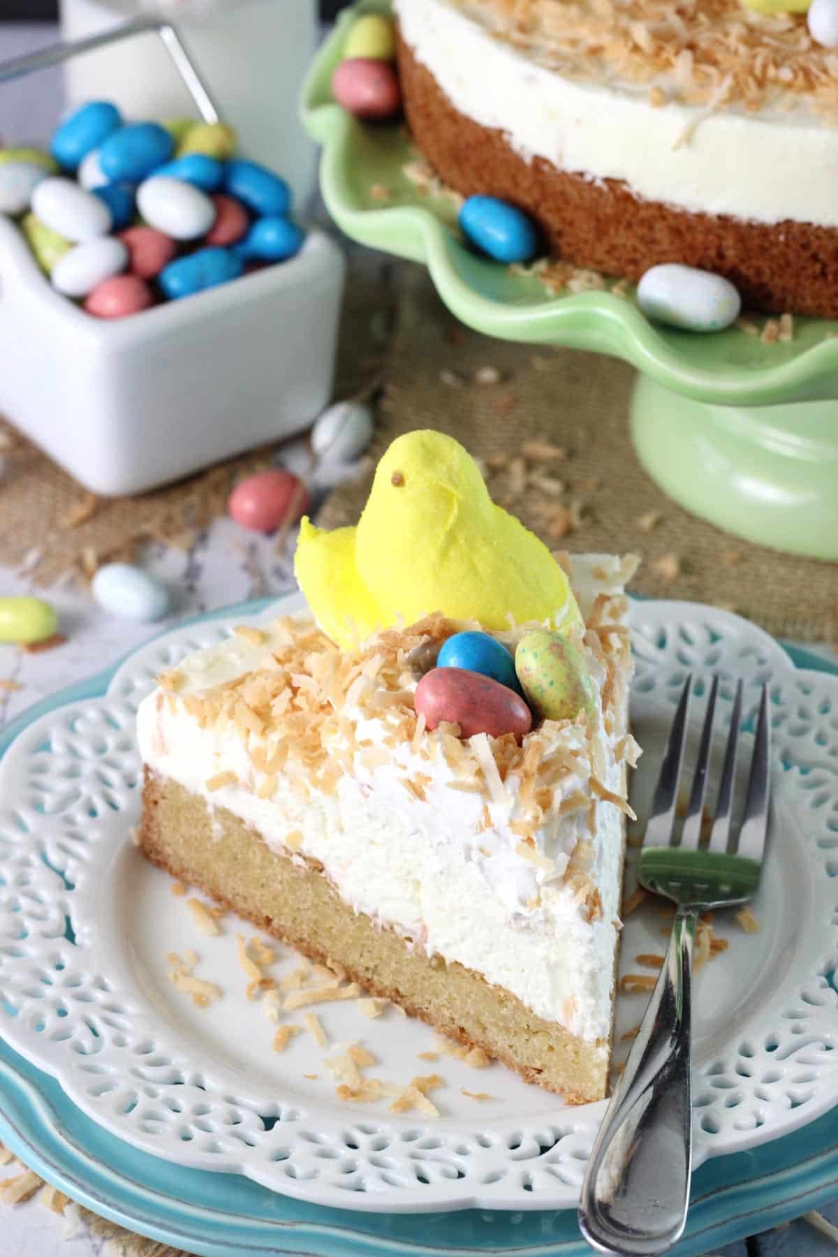 A slice of coconut blondie cheesecake on a white plate.