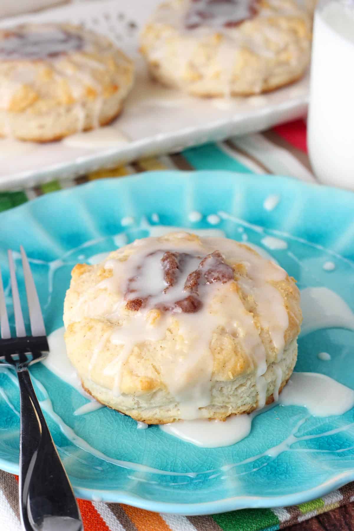 Close up of a cinnamon biscuit on a blue plate.