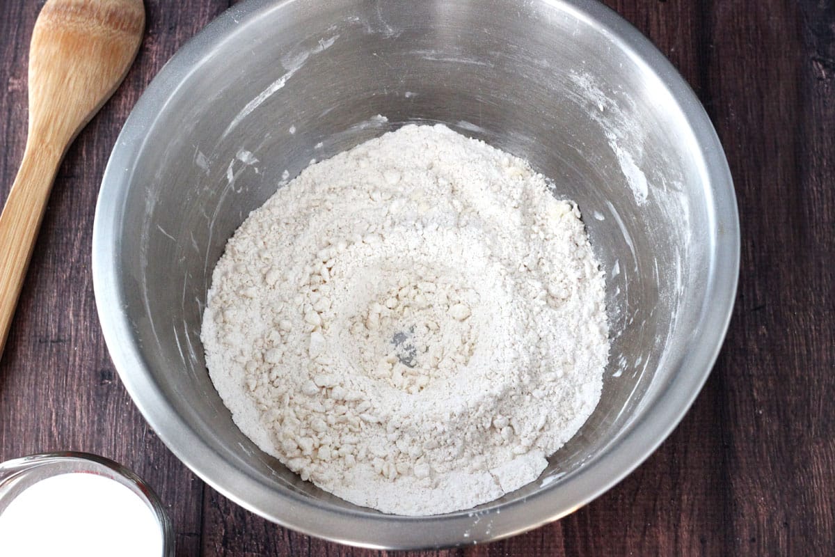 A bowl of biscuit dough with a hole in the center.