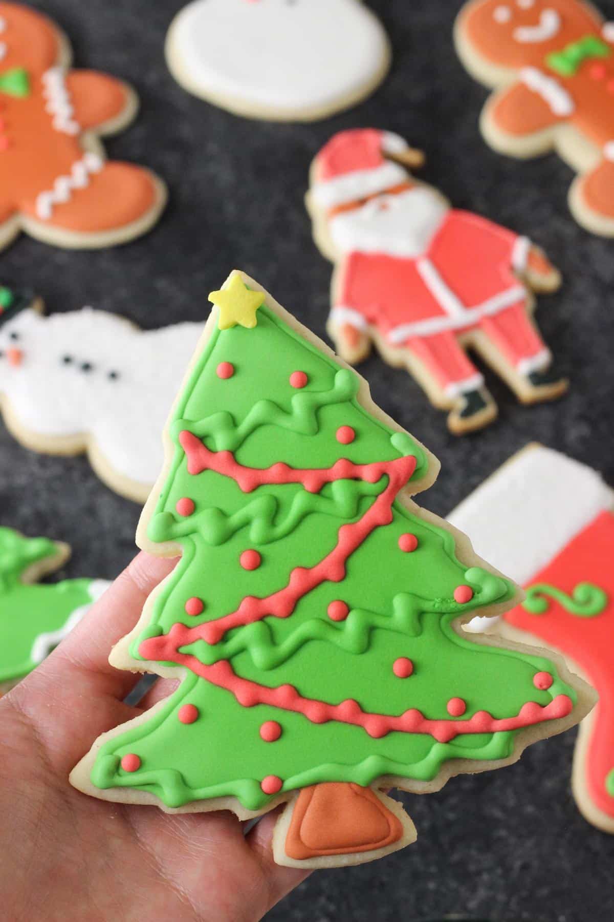 Close up of a decorated Christmas tree cutout sugar cookie.