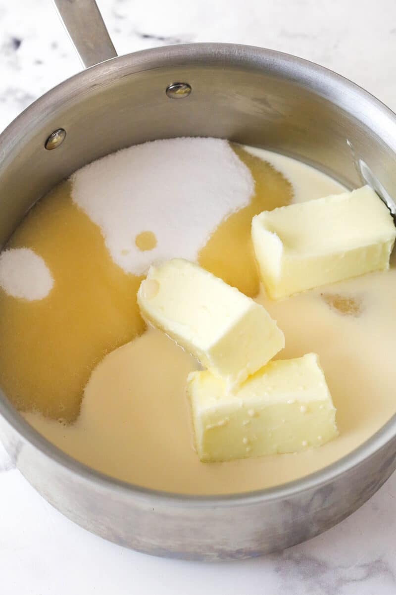 Melting together butter, sugar, and evaporated milk to make fantasy fudge.