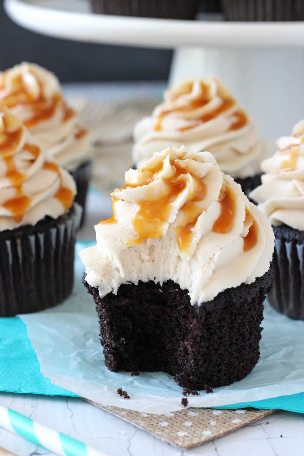 Close up of a Kahlua chocolate cupcake with salted caramel with a bite taken out of it.