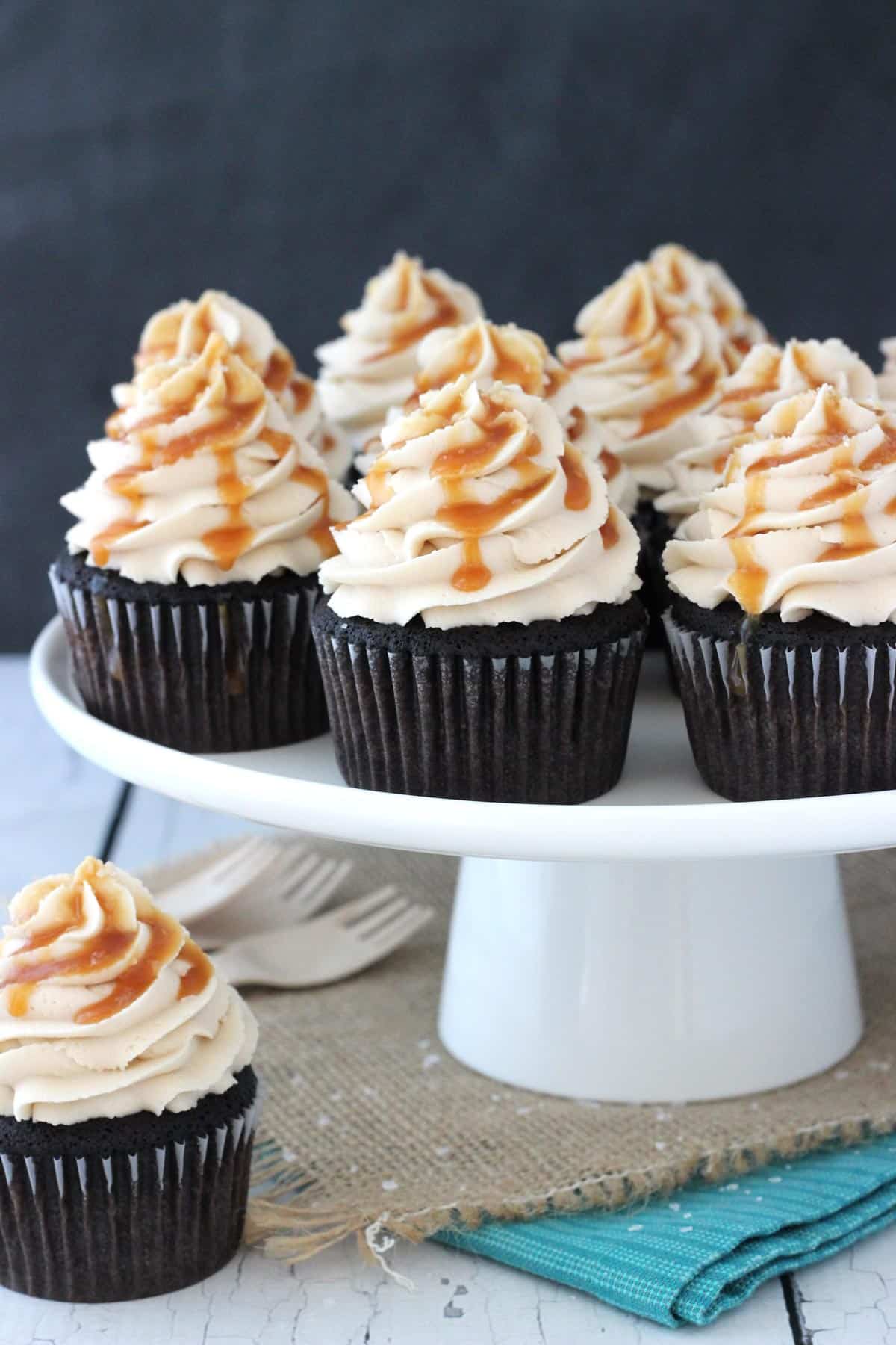 A cake plate topped with Kahlua chocolate cupcakes with salted caramel.