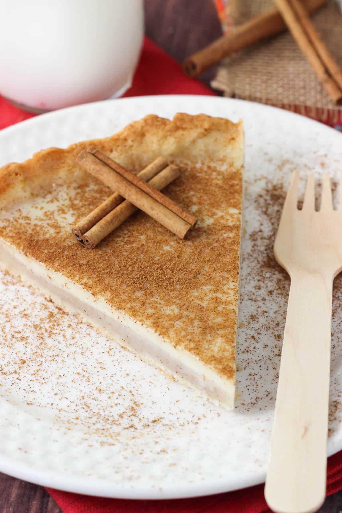 A slice of milk tart on a white plate.