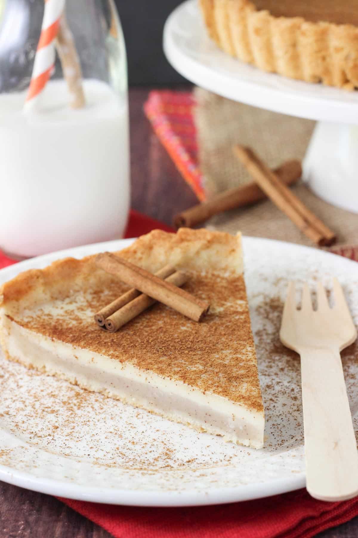 A slice of milk tart on a white plate.