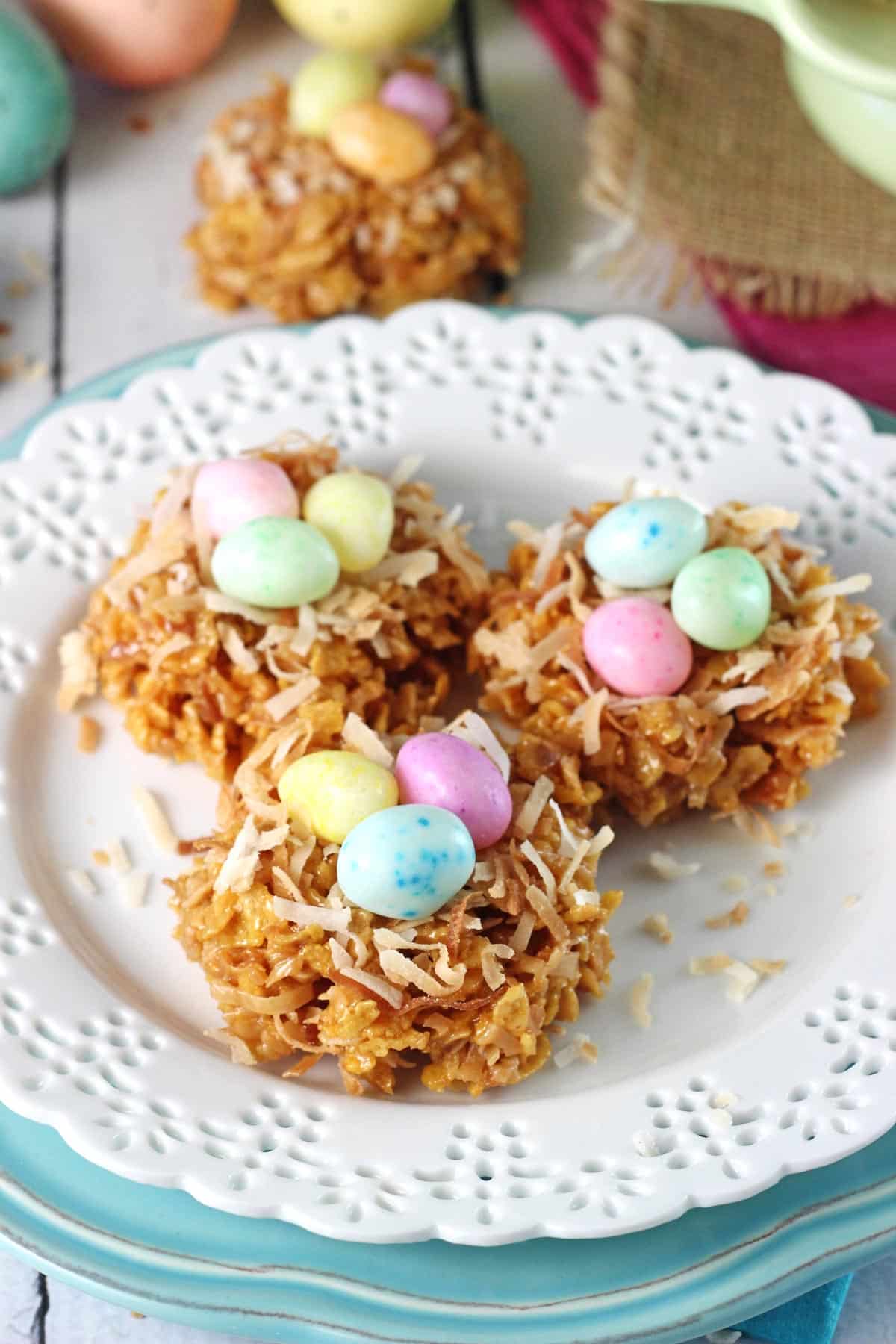 No Bake Coconut Caramel Nest Cookies Three no bake caramel coconut nest cookies on a small white plate.