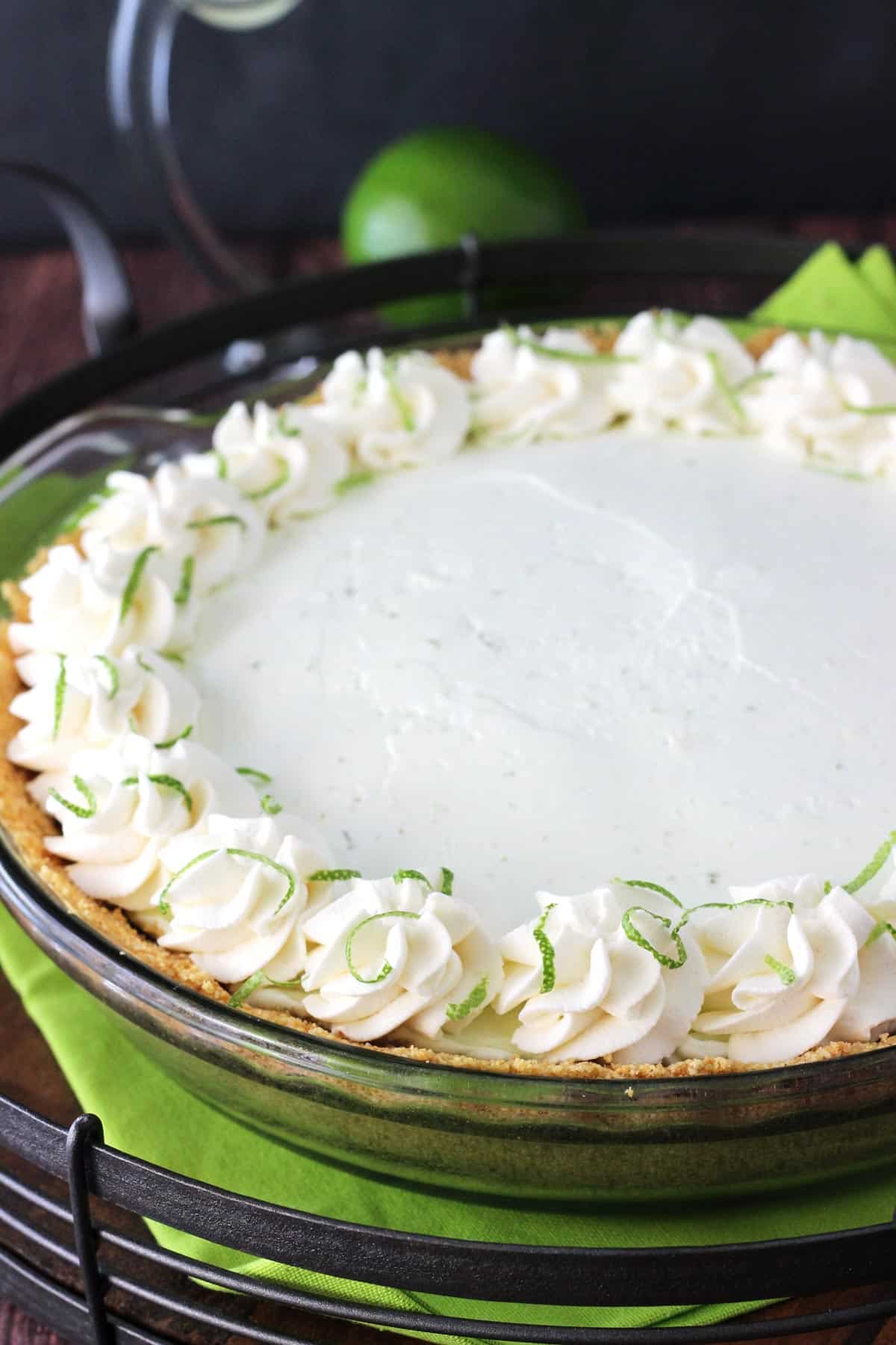 Close up of a slice of no bake margarita pie in a glass pie plan.