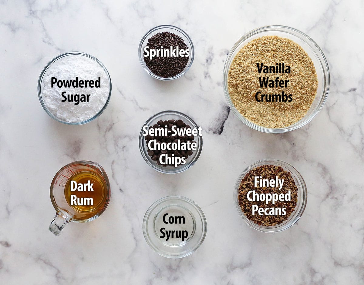 These customizable no-bake rum balls are a holiday must-have, perfect for gifting, gatherings, or adding to your festive cookie tray! Labeled ingredients for rum balls.