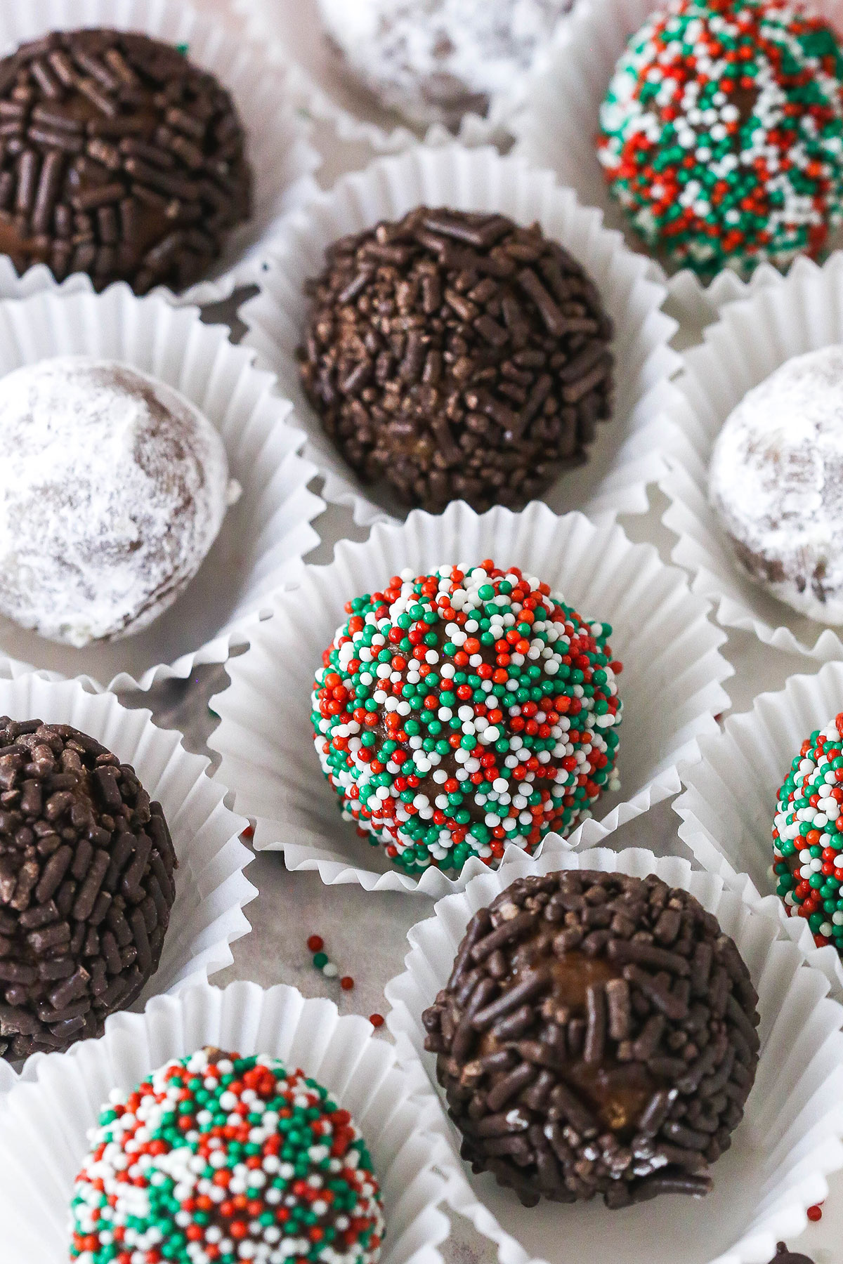 These customizable no-bake rum balls are a holiday must-have, perfect for gifting, gatherings, or adding to your festive cookie tray! Rum balls in truffle wrappers.