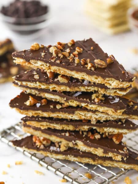 Saltine cracker toffee pieces stacked on a cooling rack.
