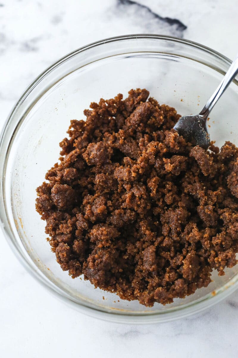Sugar, cinnamon, flour, and melted butter mixed together to make a cinnamon sugar filling for snickerdoodle cheesecake.