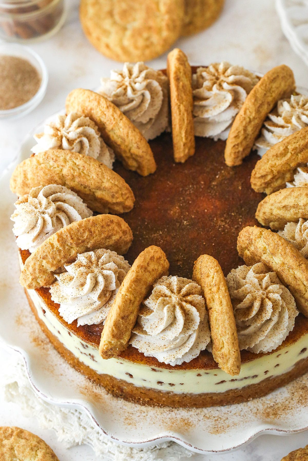 Overhead image of snickerdoodle cheesecake on a serving platter.
