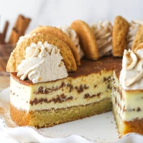 Snickerdoodle cheesecake with a slice or two taken out of it.