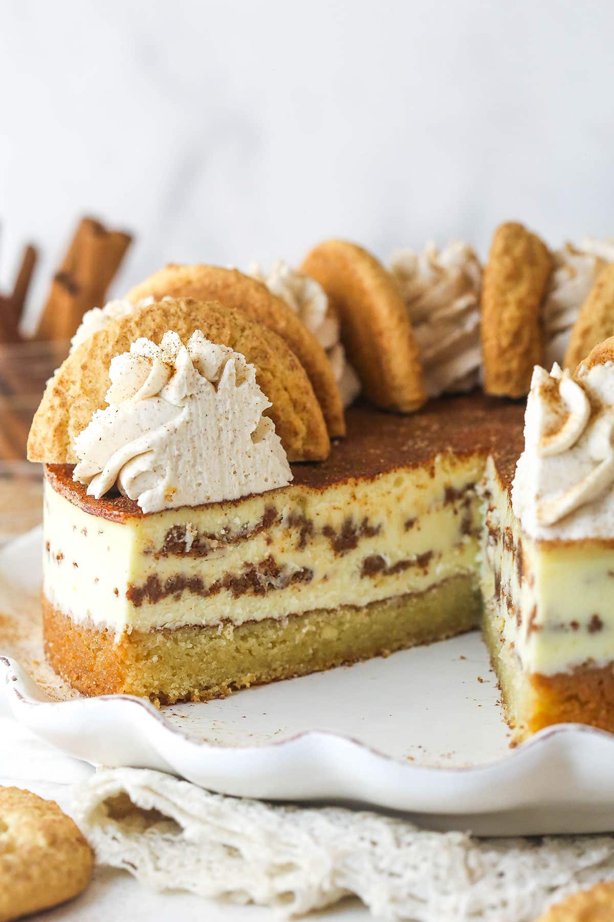 Snickerdoodle cheesecake with a slice or two taken out of it.