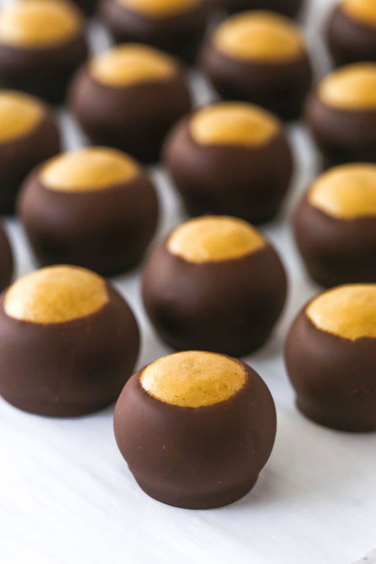 Chocolate peanut butter buckeyes on parchment paper