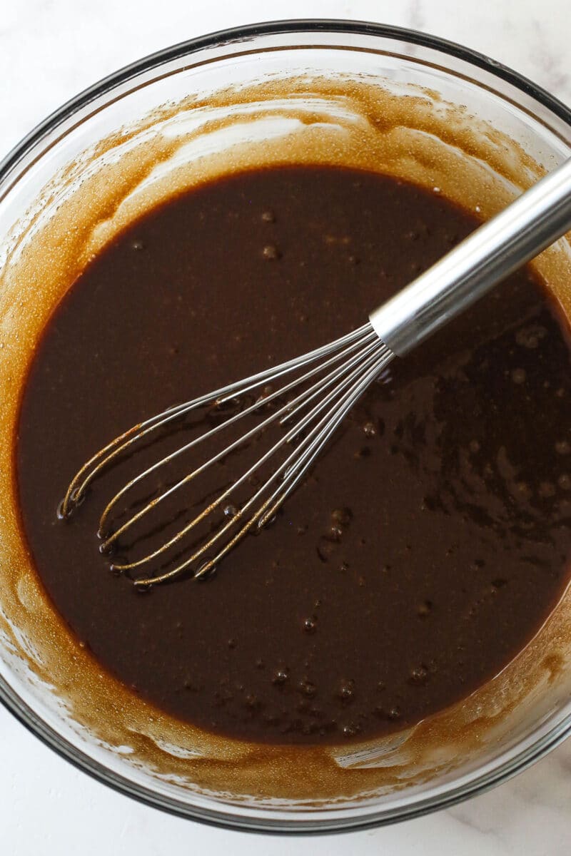 butter, chocolate, oil, vanilla, sugar and eggs combined in glass bowl