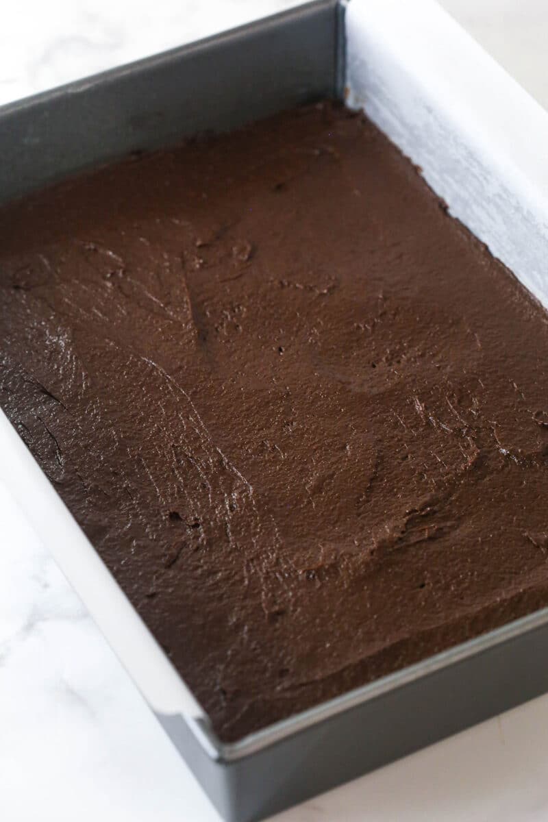 brownie batter spread into lined 9x13 pan