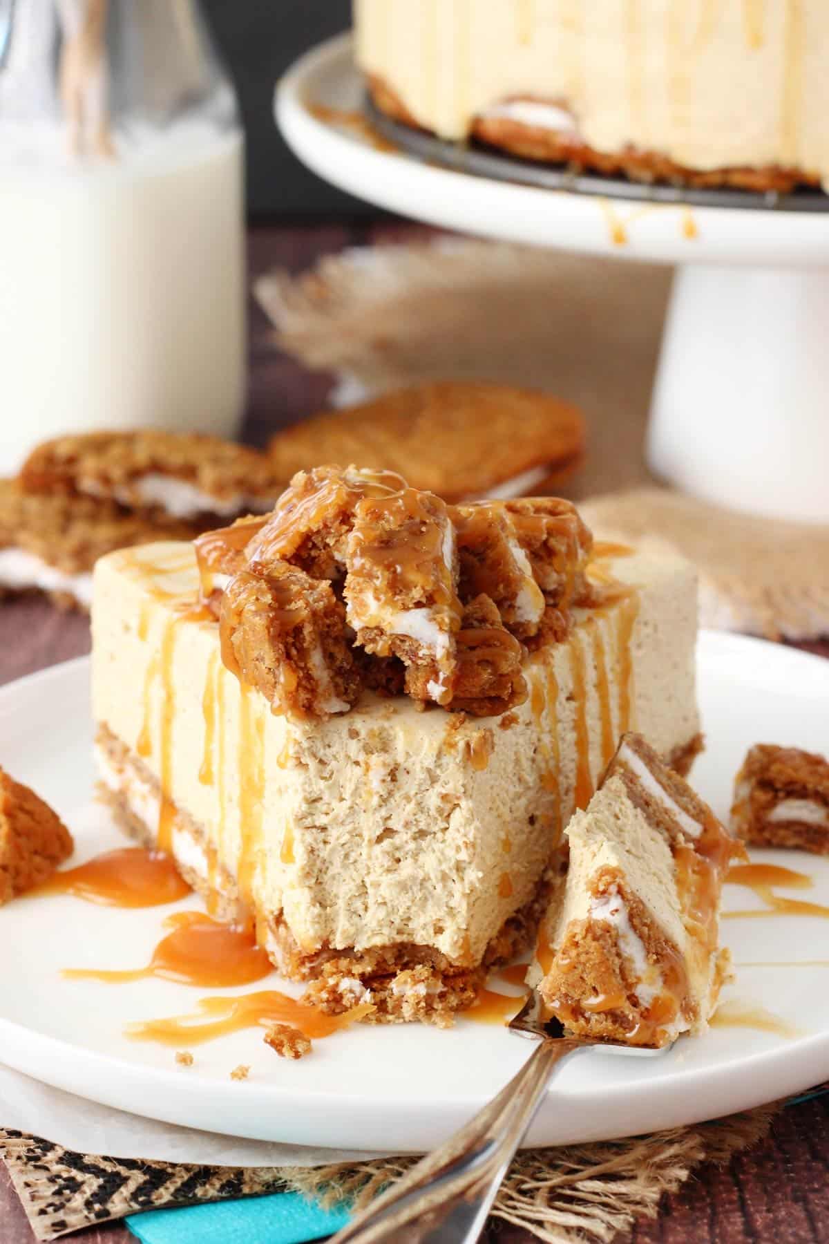 A slice of no bake oatmeal cream pie cheesecake on a white plate with a bite removed on a fork.