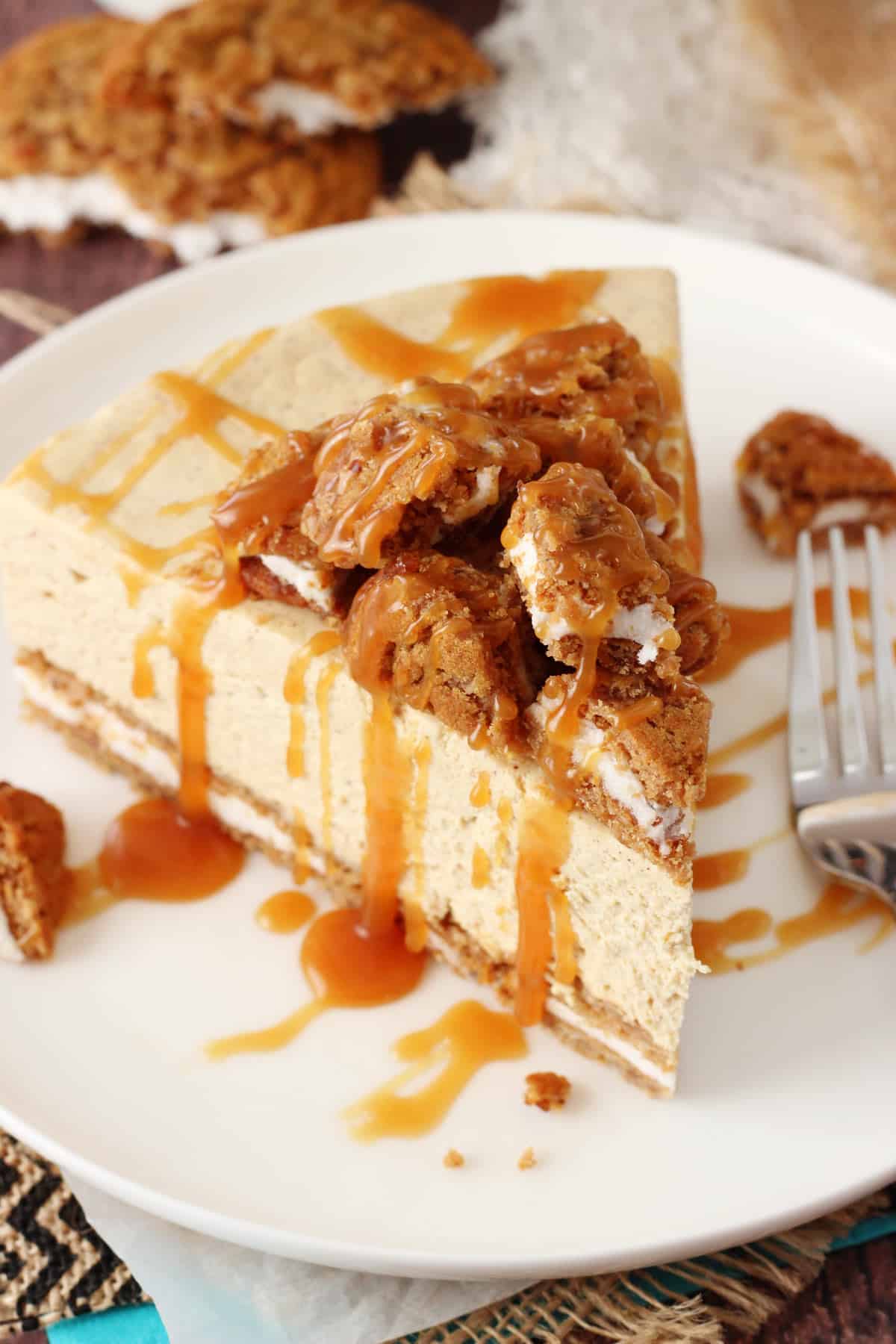 Top view of a slice of no bake oatmeal cream pie cheesecake on a white plate.