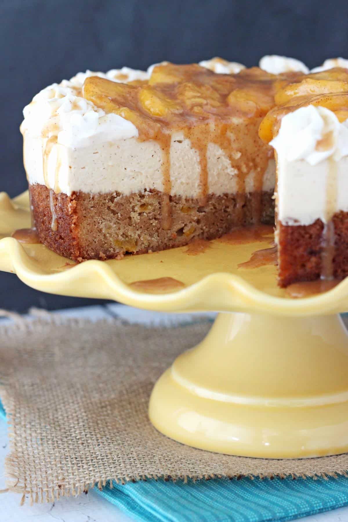 Close up of a peach caramel blondie cheesecake with a slice removed to show interior layers.