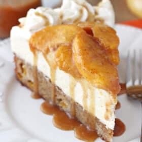 A slice of peach caramel blondie cheesecake on a white plate.
