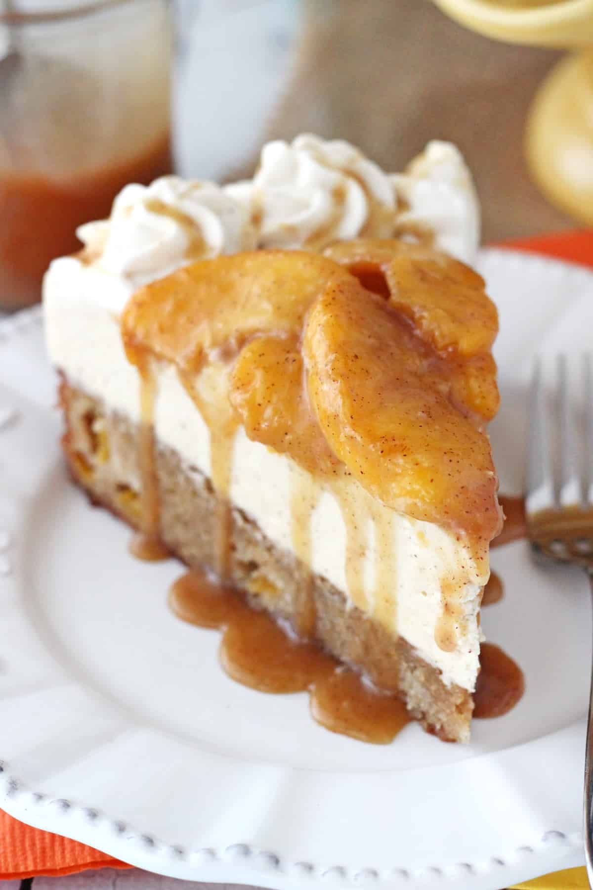 A slice of peach caramel blondie cheesecake on a white plate.