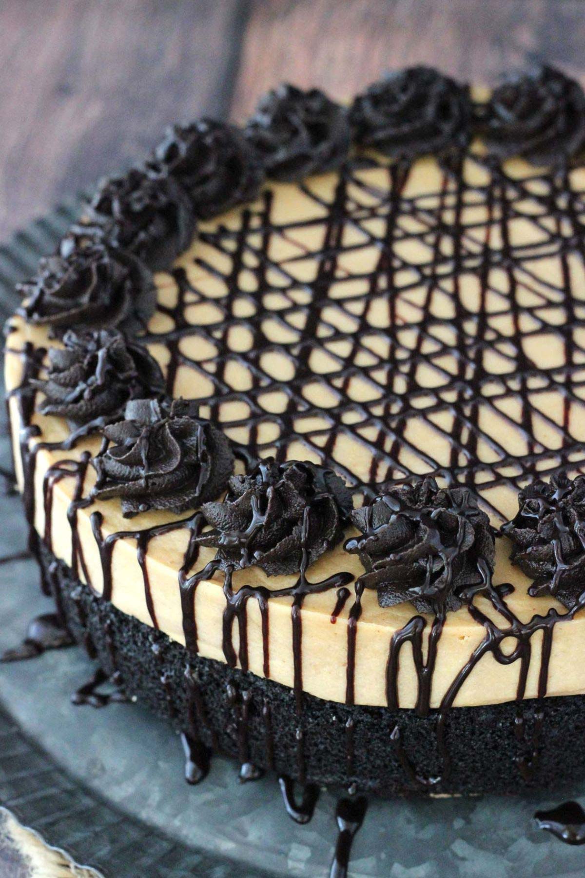 Close up of the side and top of a peanut butter truffle chocolate cake.