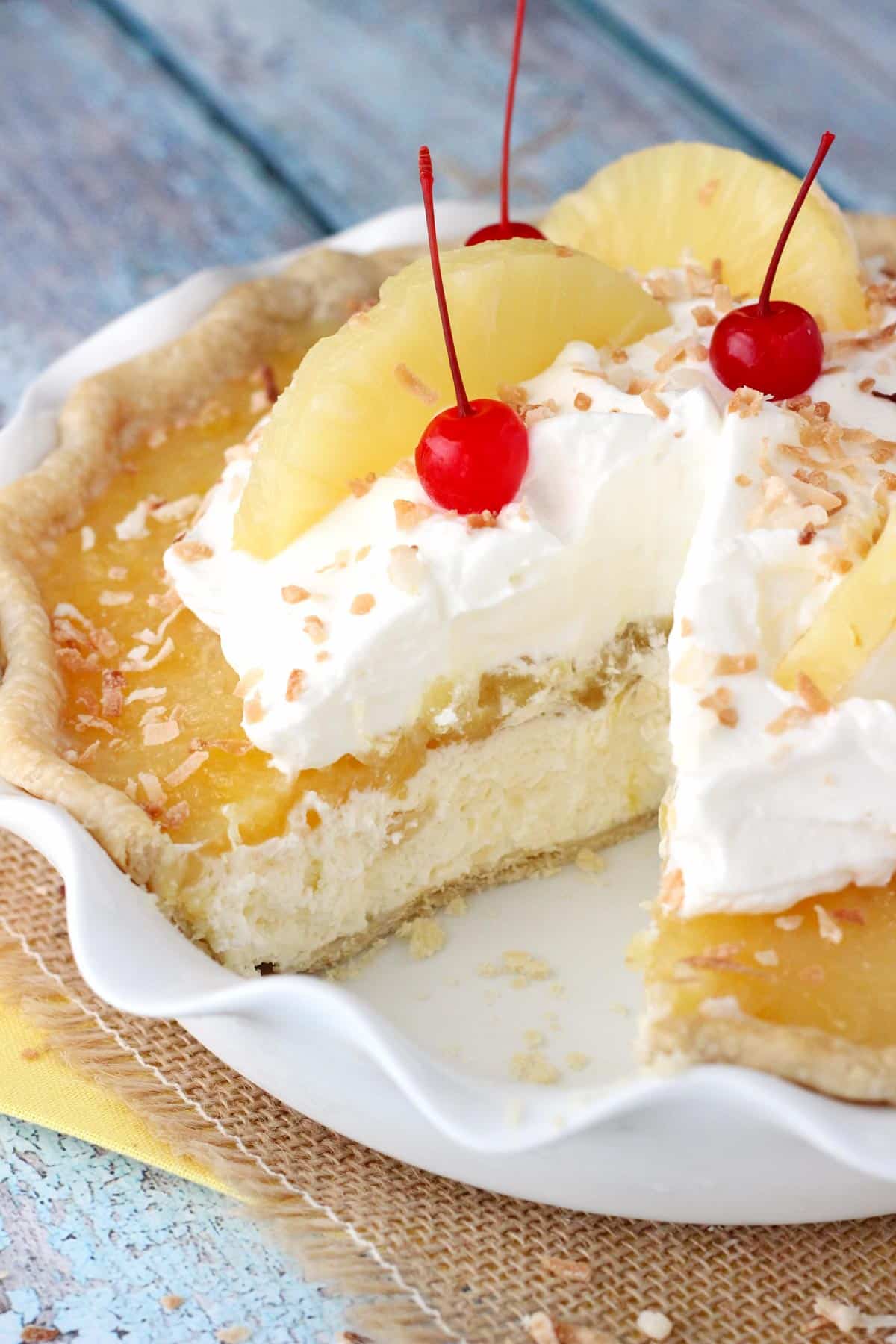 A pina colada pie with a slice removed to show layers.