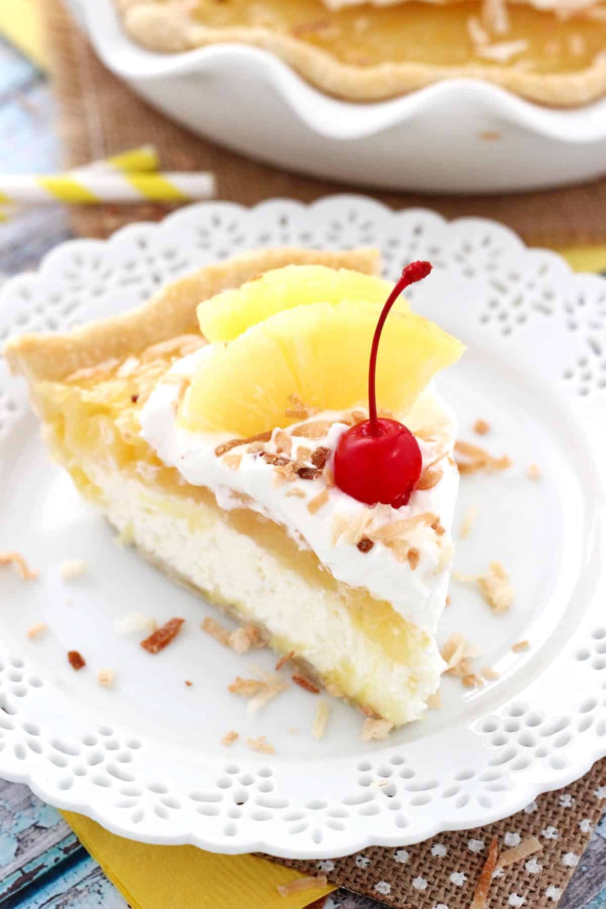Close up of a slice of pina colada pie on a white plate.