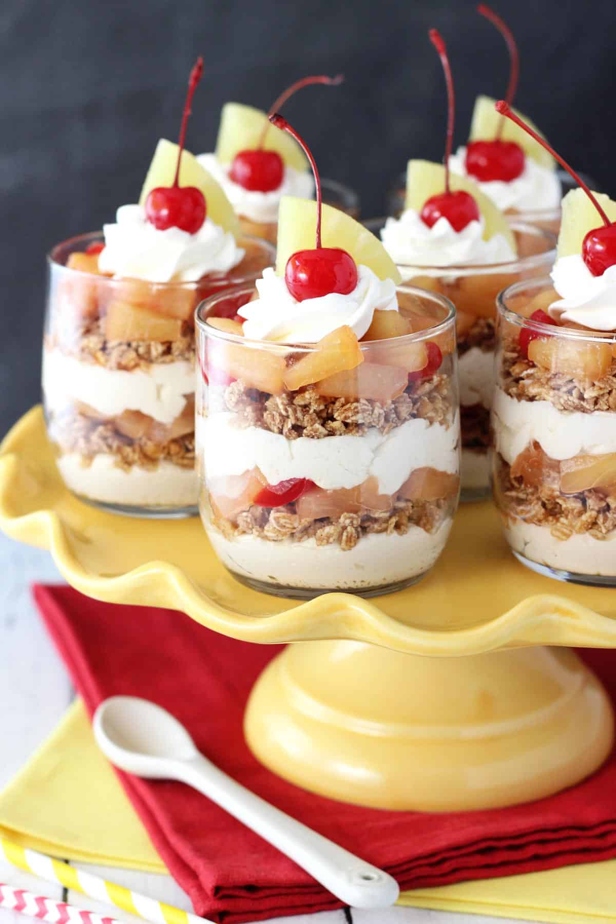 Several Pineapple Upside Down Trifles on a yellow cake stand.