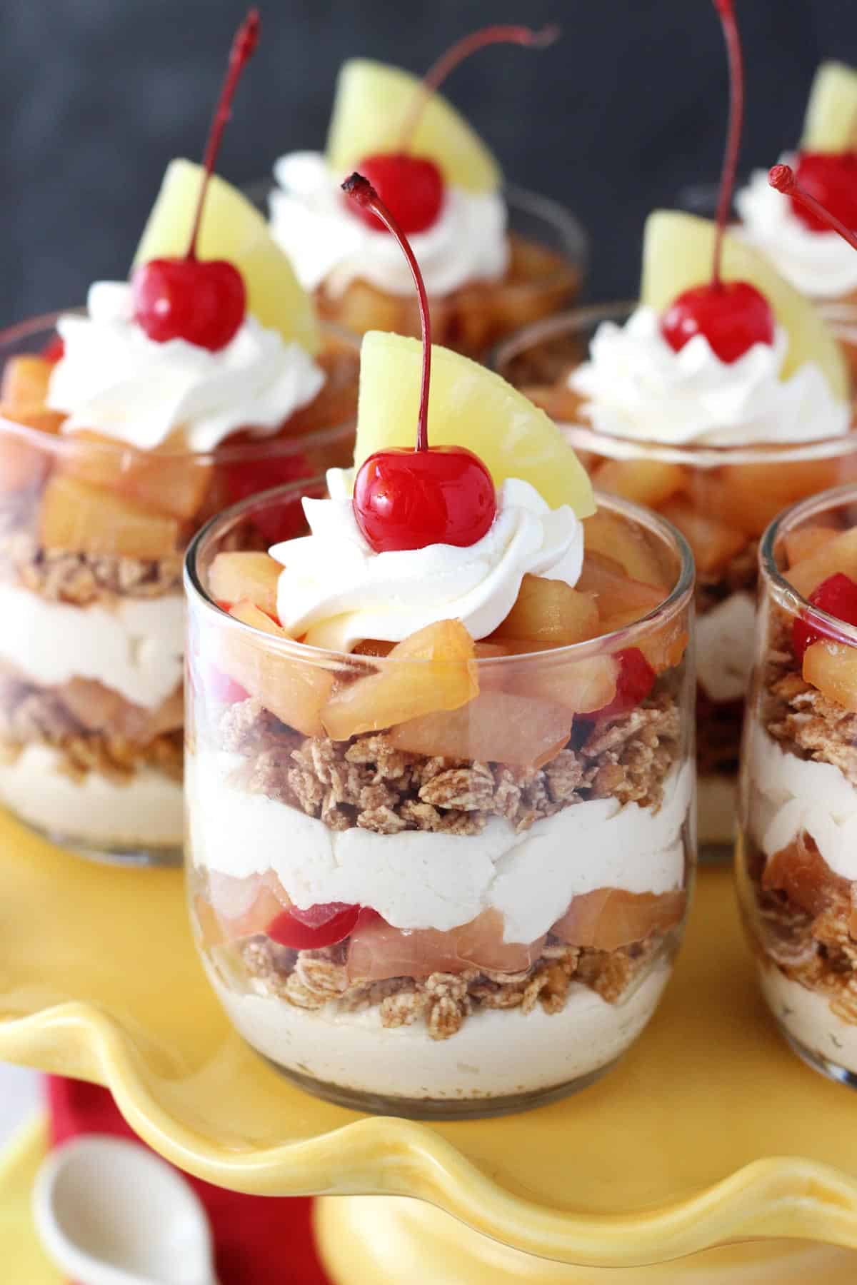 Pineapple Upside Down Trifles on a yellow cake stand.
