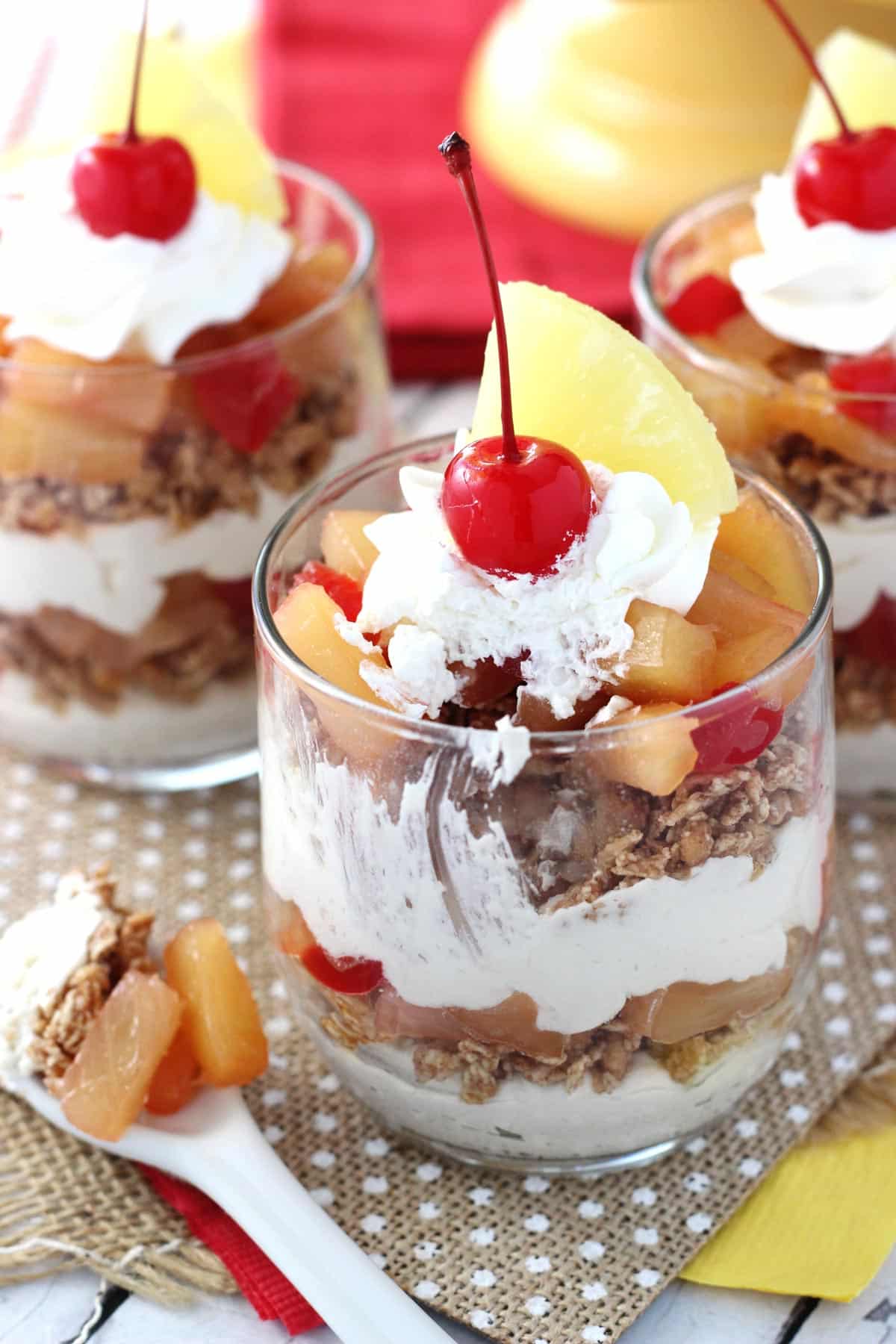 Close up of a Pineapple Upside Down Trifle with a bite removed on a spoon.
