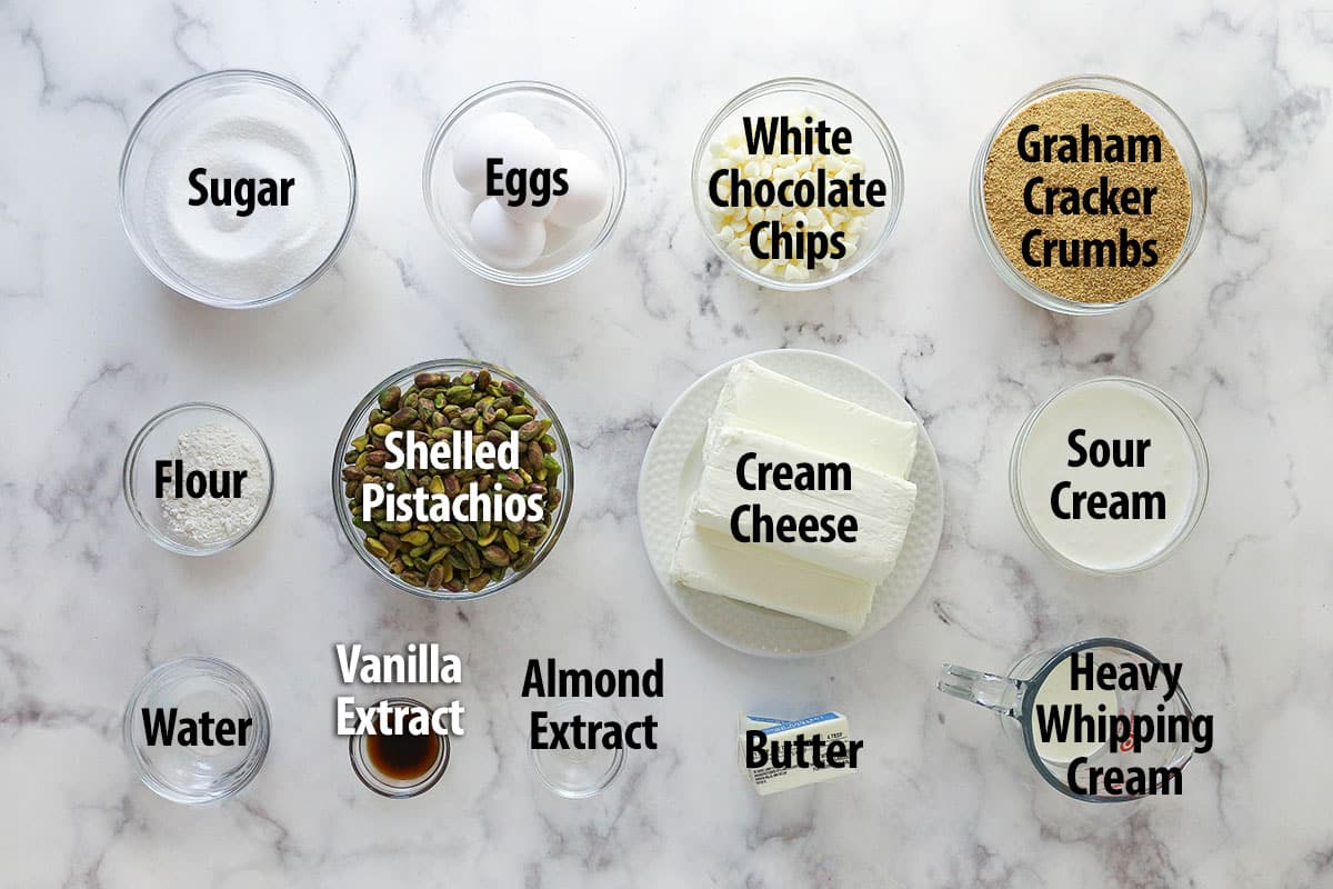 ingredients for pistachio cheesecake on marble background