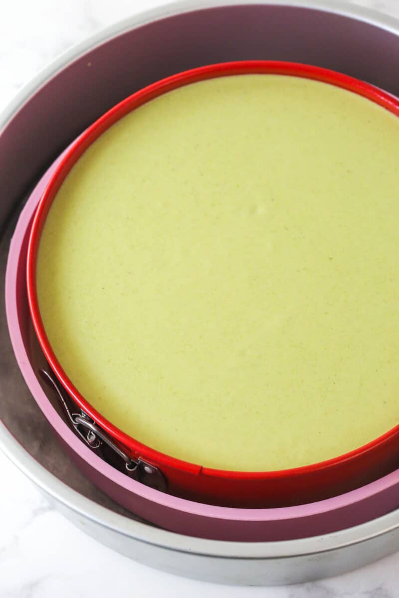 unbaked pistachio cheesecake in pan and water bath