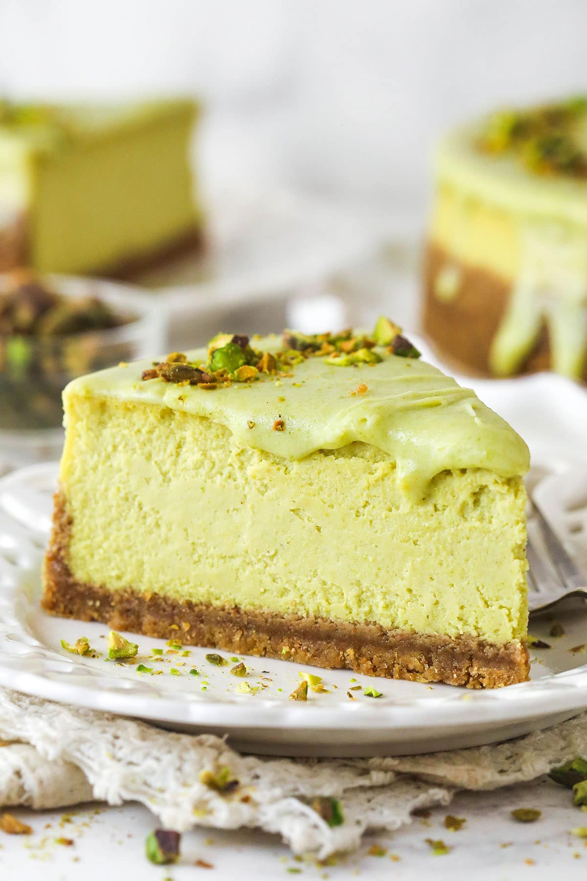 slice of pistachio cheesecake on white plate