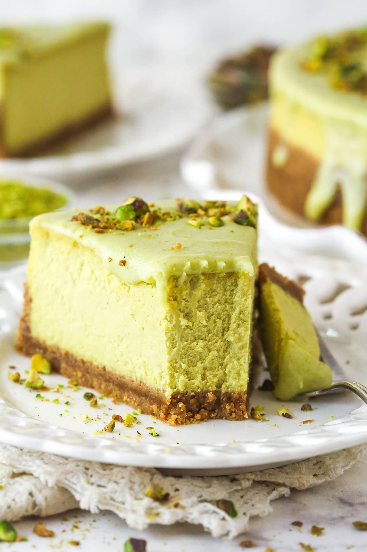 slice of pistachio cheesecake with a bite taken out