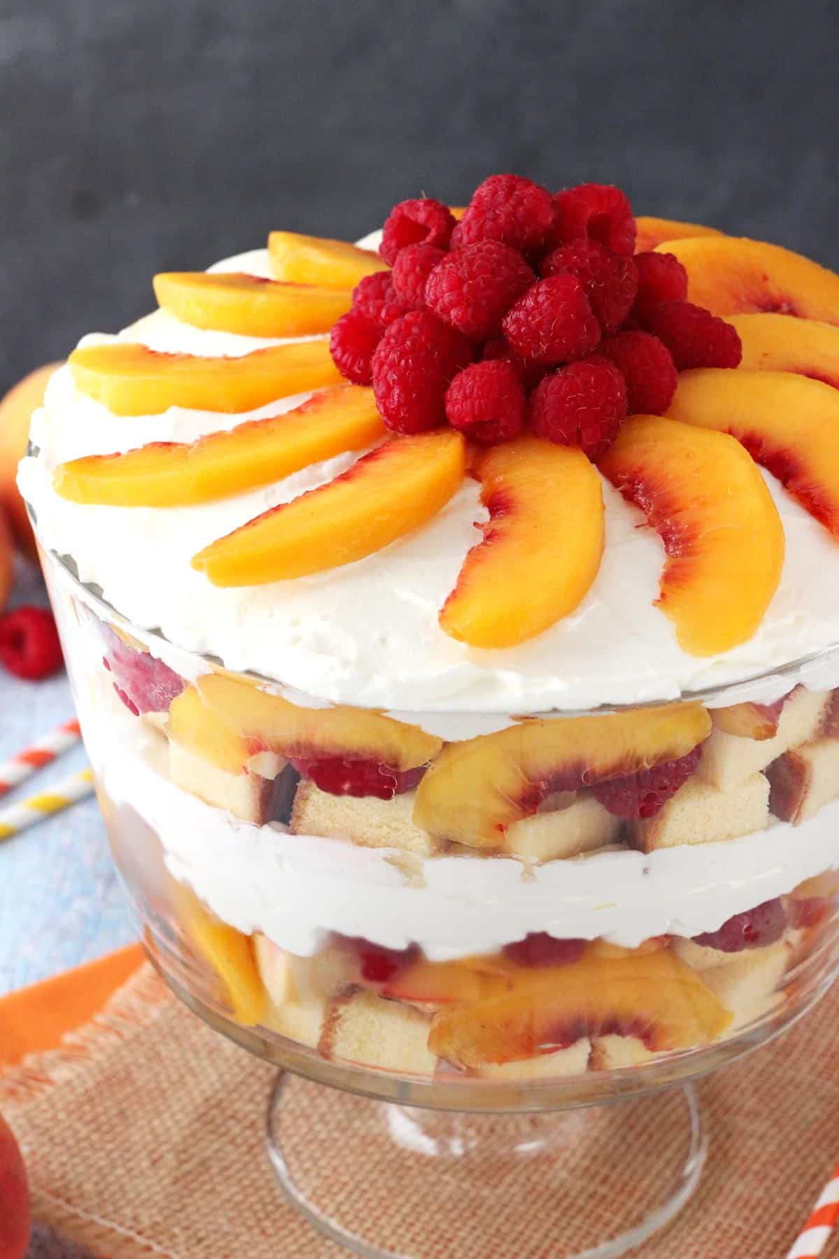 Raspberry Peach Sangria Trifle Close up of a raspberry peach sangria trifle in a glass trifle bowl.