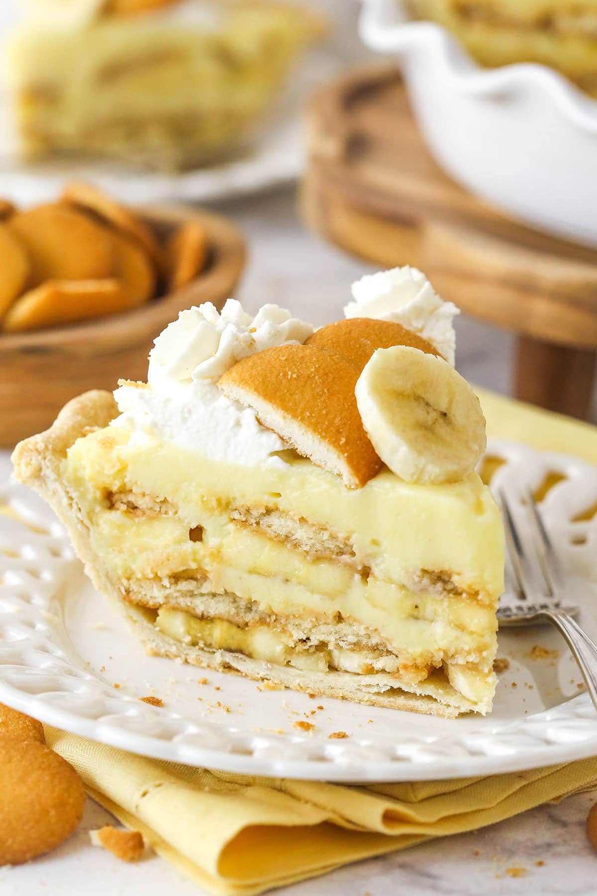 A slice of banana pudding pie on a white plate