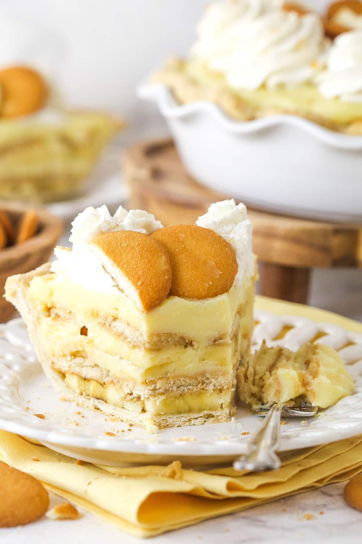 A slice of banana pudding pie with a bite missing