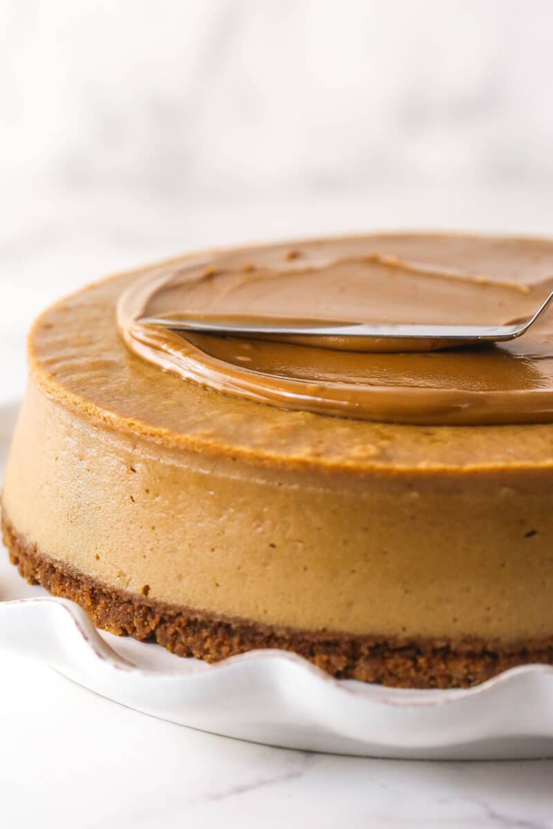 With a Biscoff cookie crust and cookie spread in the filling, this Biscoff Cheesecake tastes just like the cookies. Spreading Biscoff cookie butter on top of a cheesecake