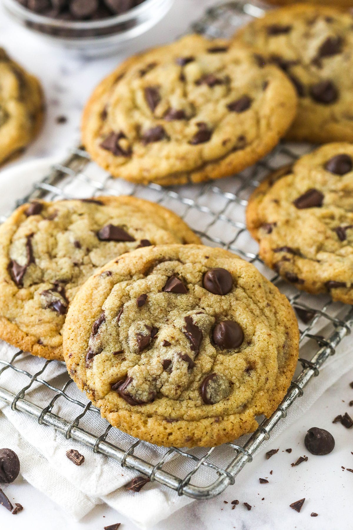 These Brown Butter Chocolate Chip Cookies take classic chocolate chip cookies to a whole new level, with a rich and slightly nutty flavor. Angled view of brown butter chocolate chip cookies on a cooling rack