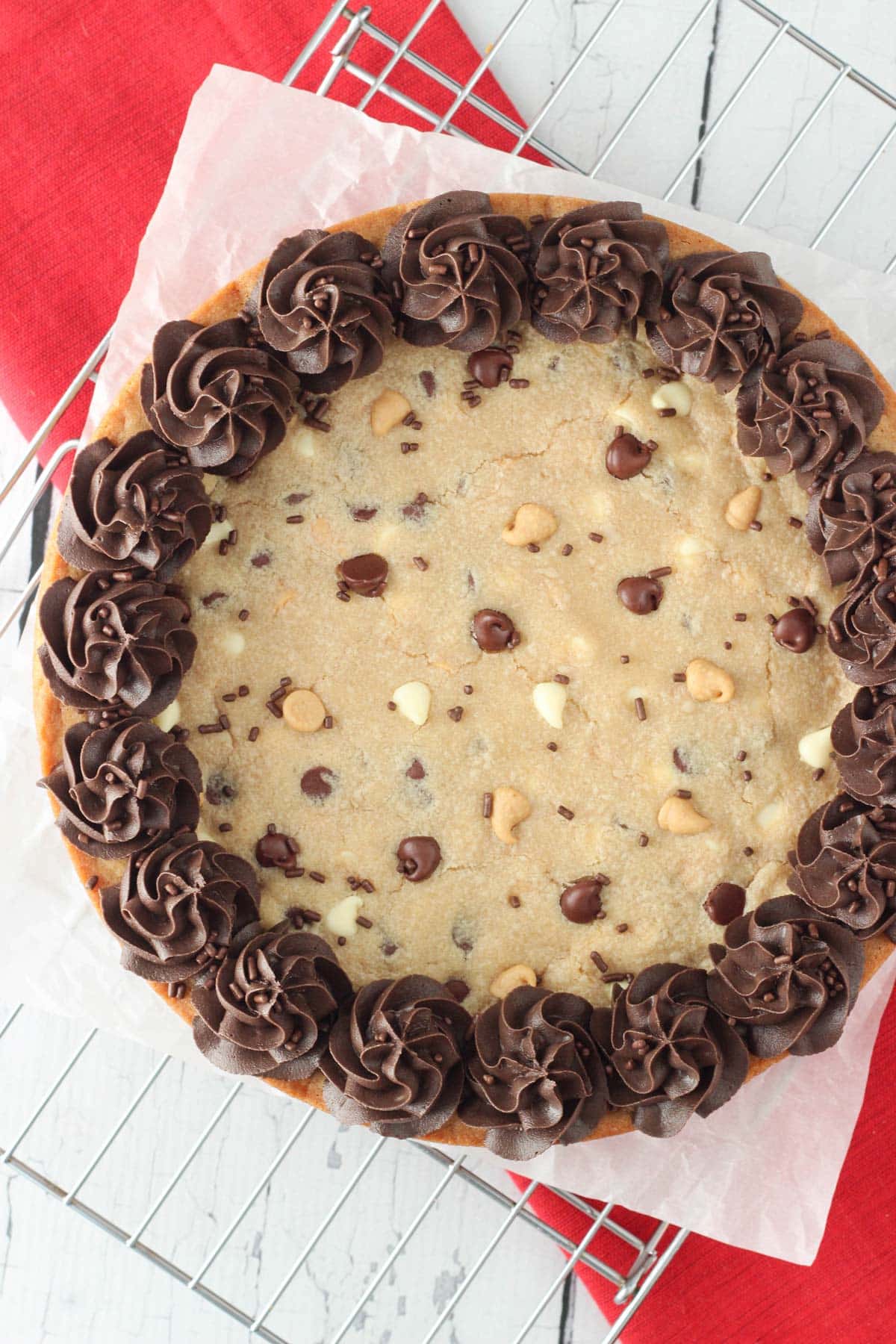 Overhead view of a decorated triple chocolate chip cookie cake.