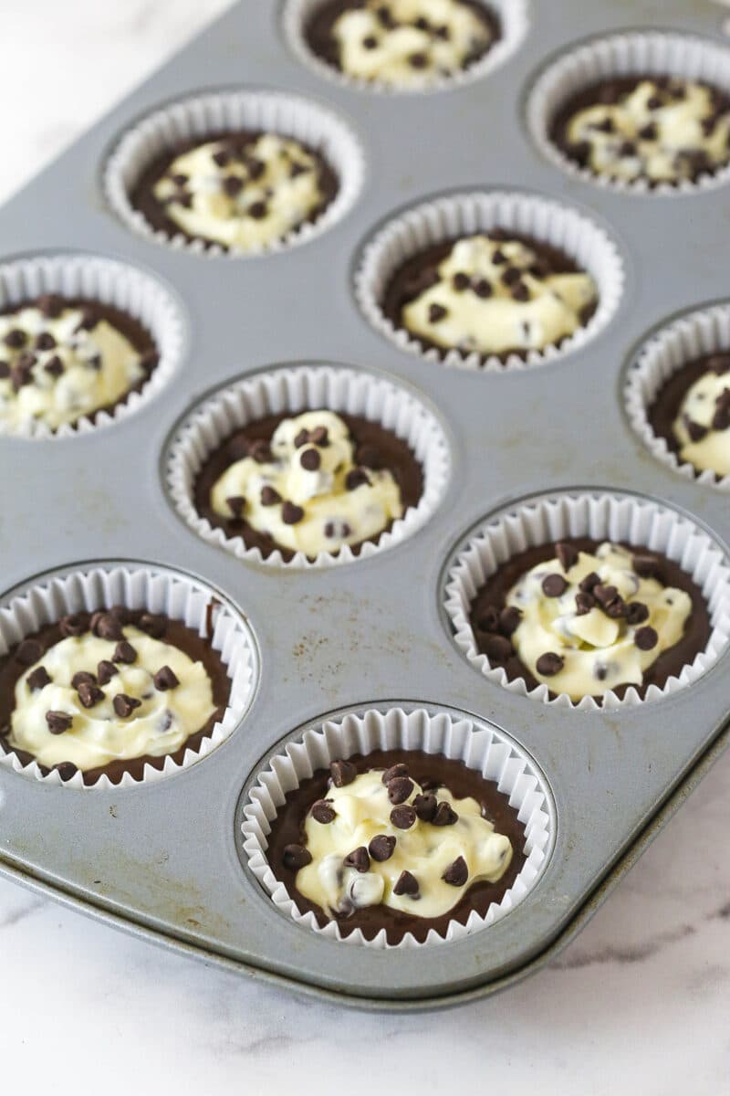 These Black Bottom Cupcakes combine two desserts in one with a rich chocolate cupcake and a creamy chocolate chip cheesecake filling. Chocolate cupcake batter and cheesecake filling in cupcake liners